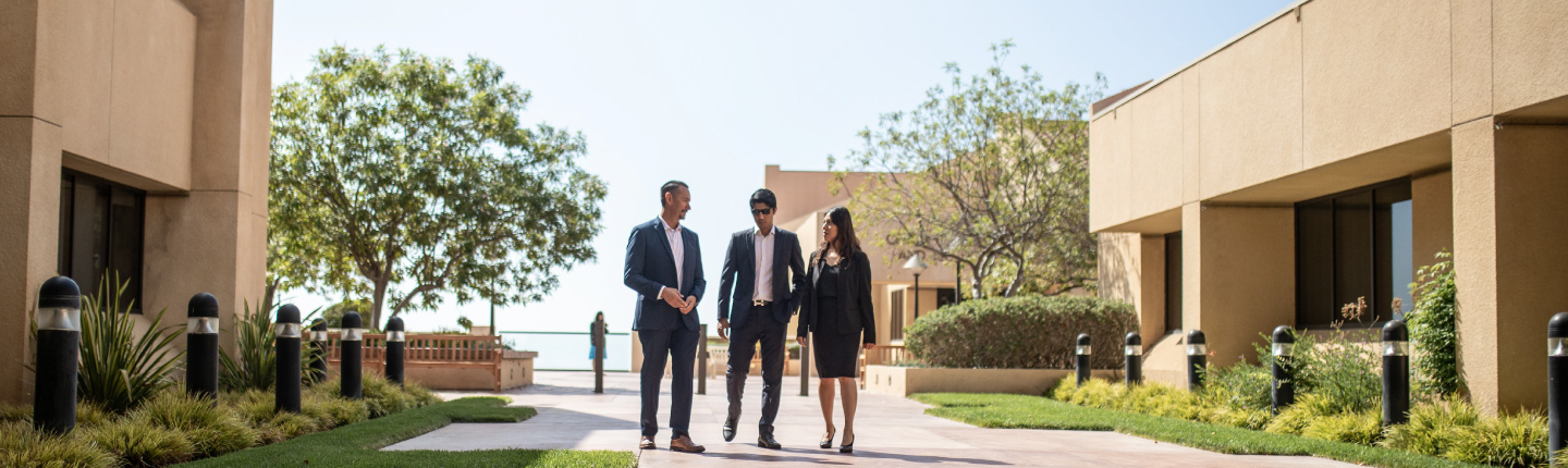 Financial Aid officer walking with student and professor