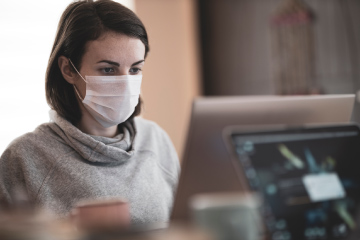 Alumnus working on computer during COVID-19 pandemic