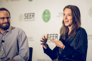 Speaker on stage at SEER Symposium