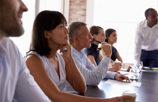 Executives in classroom with professor speaking